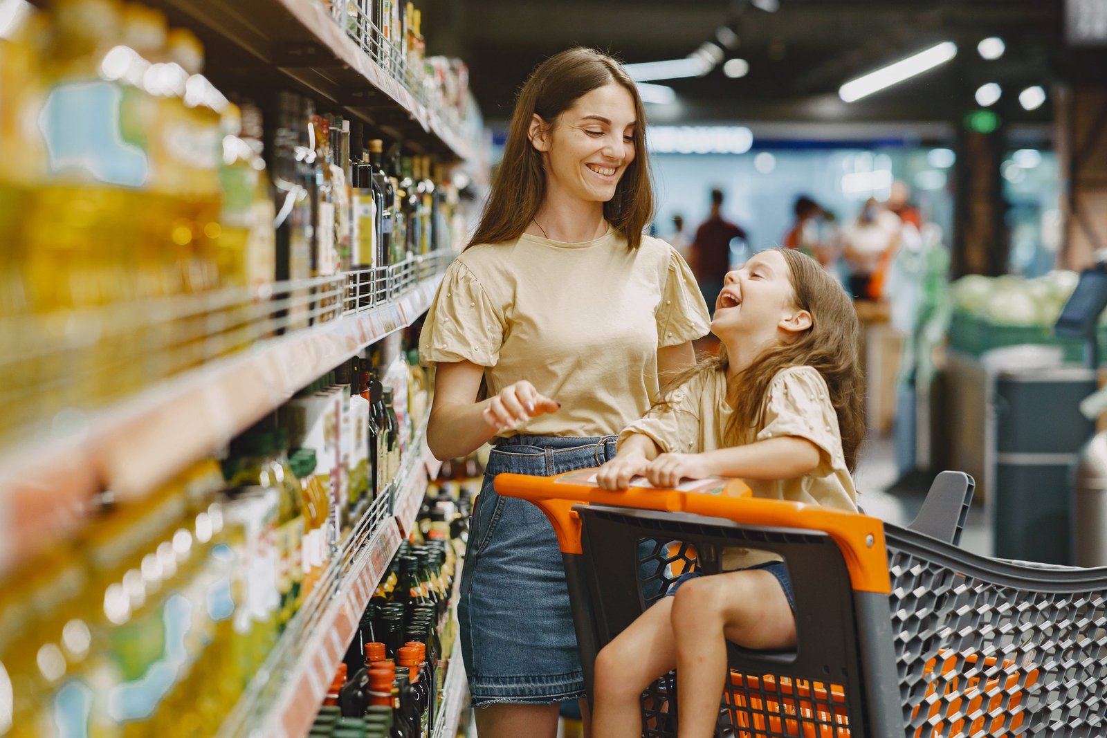 family-at-the-supermarket-woman-in-a-brown-t-shirt-people-choose-products-mother-with-daughter-scaled.jpg